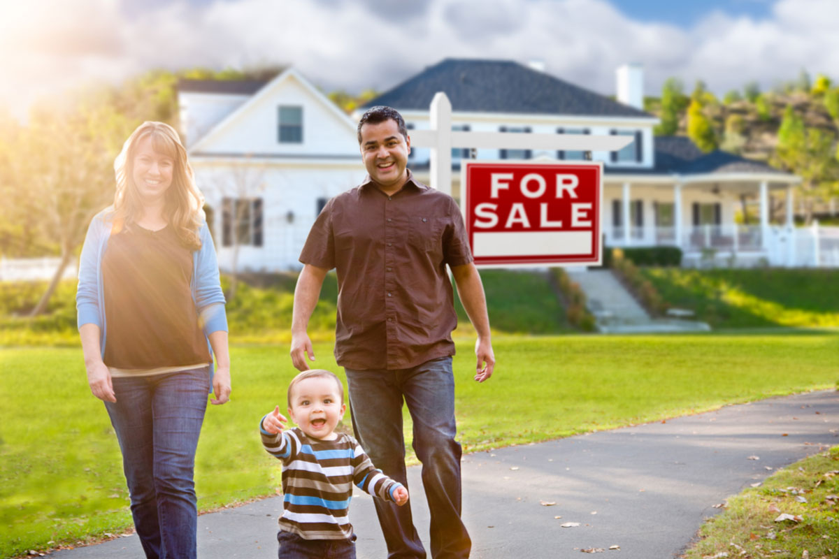 Family outside a home for sale