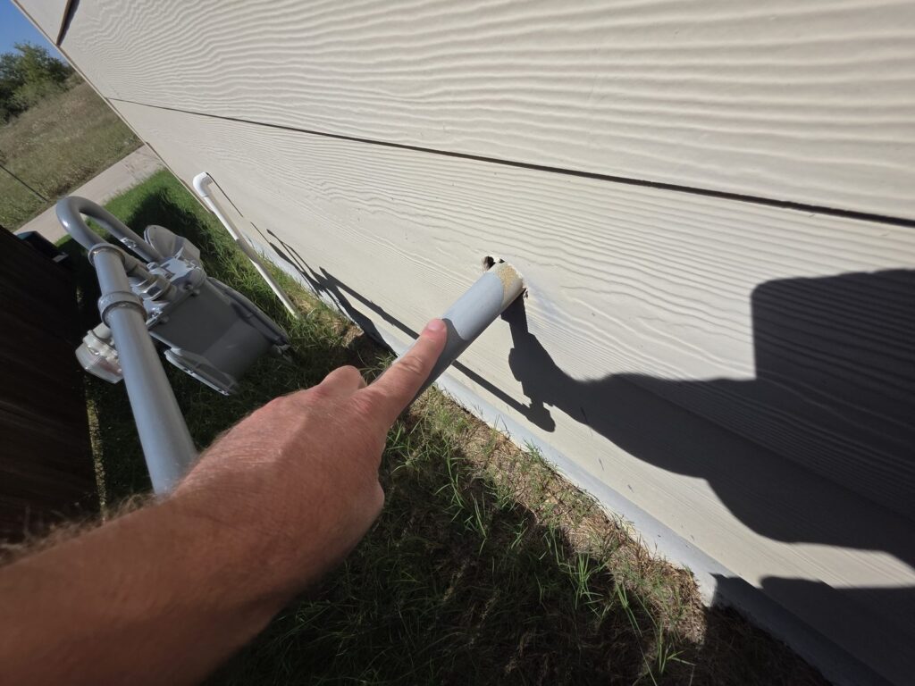 Inspector pointing out an exterior siding detail