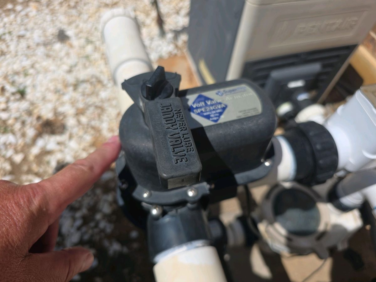 Inspector checking a pool valve actuator