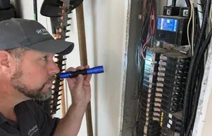 Inspector evaluating an electrical panel